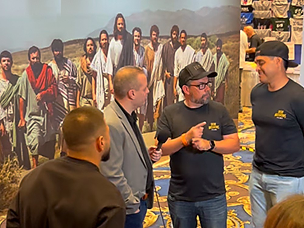 Lagundo Sandoval with attendees at a large conference